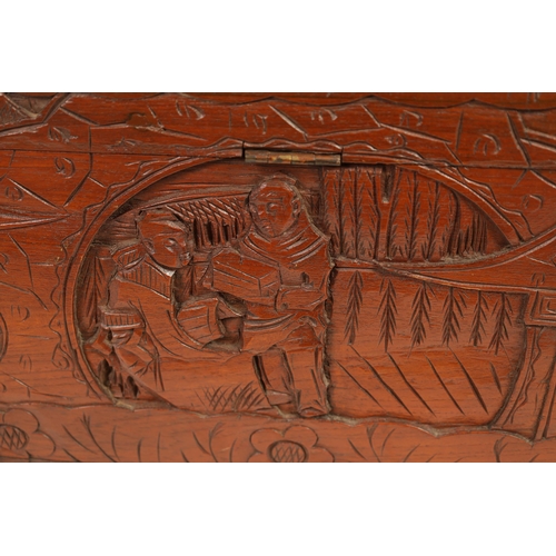 239 - AN EARLY 20TH CENTURY CHINESE CARVED HARDWOOD BLANKET BOX with carved figural landscape panels to th... 