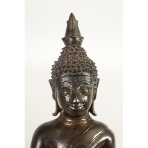 245 - AN EARLY TIBETAN BRONZE SEATED BUDDHA depicted in a cross legged pose with ornamental head dress; on... 