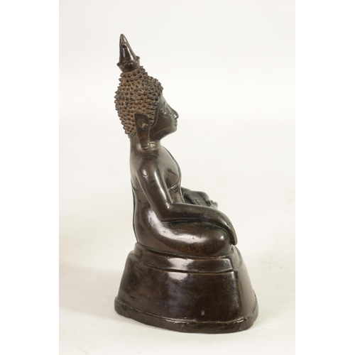 245 - AN EARLY TIBETAN BRONZE SEATED BUDDHA depicted in a cross legged pose with ornamental head dress; on... 