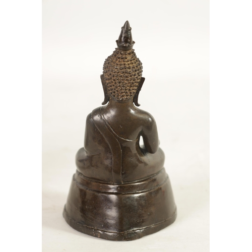 245 - AN EARLY TIBETAN BRONZE SEATED BUDDHA depicted in a cross legged pose with ornamental head dress; on... 