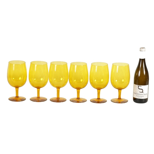 25 - A SET OF SIX URANIUM AMBER GLASS WINE GOBLETS the deep rounded bowls on short stems and flat circula... 