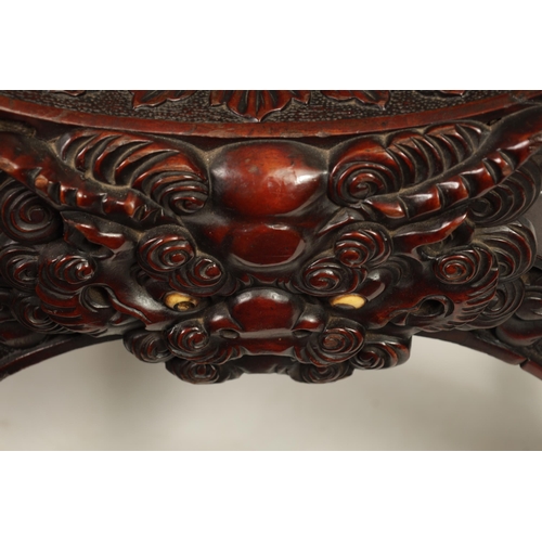 257 - AN IMPRESSIVE LATE 19TH CENTURY CHINESE HARDWOOD X FRAME THRONE CHAIR profusely carved with a panell... 