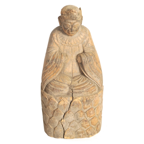 258 - A CHINESE MING PERIOD CARVED WOODEN FIGURE OF AN IMMORTAL raised on a caved scale base (27.5cm high)