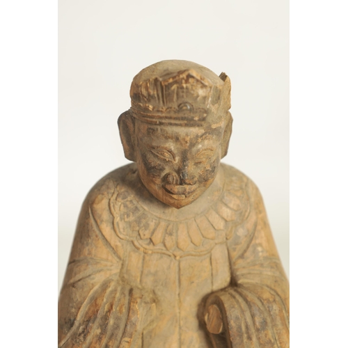 258 - A CHINESE MING PERIOD CARVED WOODEN FIGURE OF AN IMMORTAL raised on a caved scale base (27.5cm high)