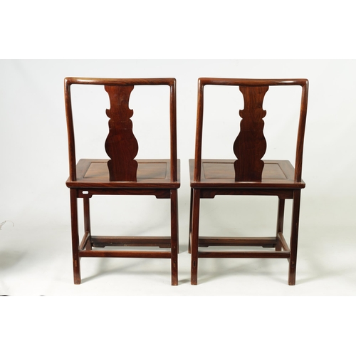 264 - A PAIR OF 19TH CENTURY CHINESE HARDWOOD HALL CHAIRS with vase-shaped solid centre splats within a ro... 