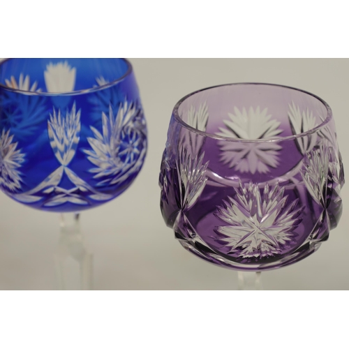 27 - AN 8 PIECE PART SUITE OF BOHEMIAN COLOURED TABLE GLASSWARE each piece with cut swirling starwork dif... 