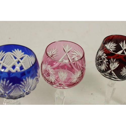 27 - AN 8 PIECE PART SUITE OF BOHEMIAN COLOURED TABLE GLASSWARE each piece with cut swirling starwork dif... 