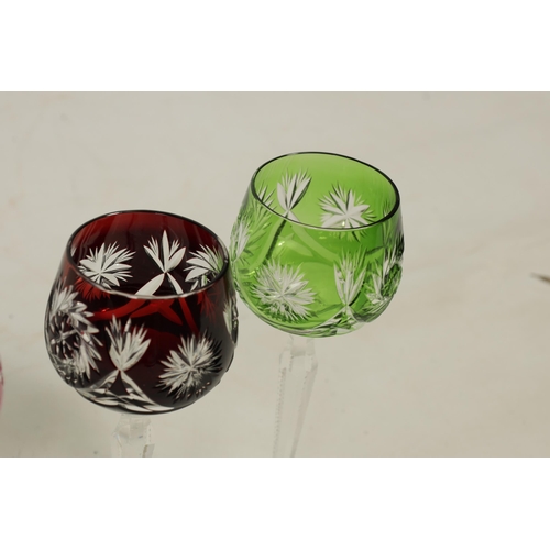 27 - AN 8 PIECE PART SUITE OF BOHEMIAN COLOURED TABLE GLASSWARE each piece with cut swirling starwork dif... 