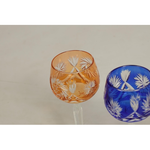 27 - AN 8 PIECE PART SUITE OF BOHEMIAN COLOURED TABLE GLASSWARE each piece with cut swirling starwork dif... 