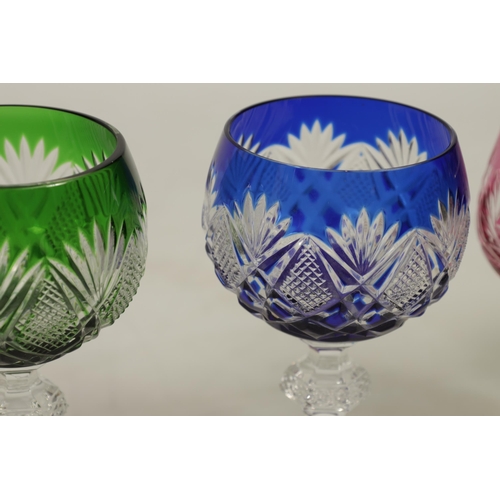 27 - AN 8 PIECE PART SUITE OF BOHEMIAN COLOURED TABLE GLASSWARE each piece with cut swirling starwork dif... 