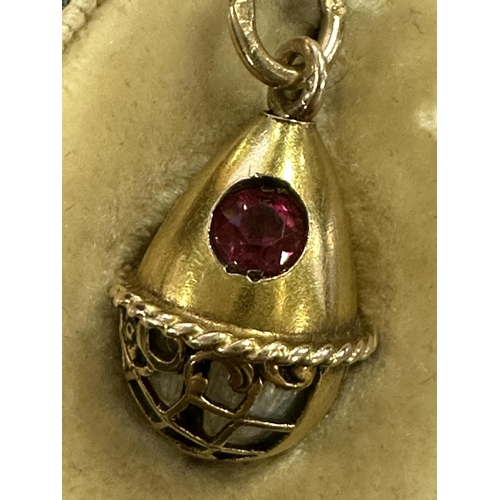 274 - A LATE 19TH CENTURY FABERGE 14CT GOLD ENAMEL AND RUBY PENDANT EGG, WORKMASTER HENRIK WIGSTROM the eg... 