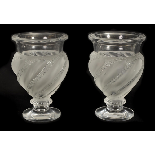 28 - A PAIR OF LALIQUE FROSTED AND CLEAR GLASS “ERMENONVILLE” VASES of twisted design on circular feet, e... 