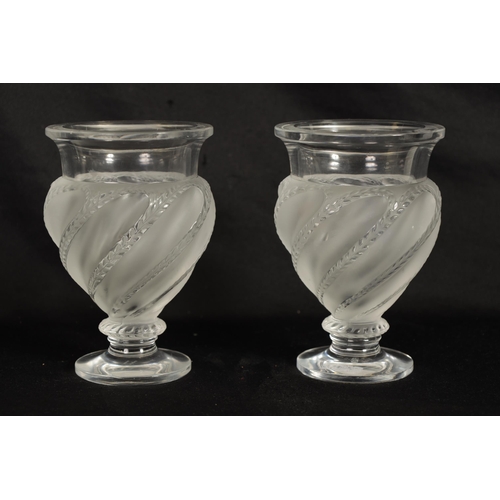 28 - A PAIR OF LALIQUE FROSTED AND CLEAR GLASS “ERMENONVILLE” VASES of twisted design on circular feet, e... 