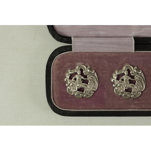 299 - A CASED SET OF 6 LATE VICTORIAN SILVER DRESS BUTTONS of embossed Rococo design with pierced seated f... 