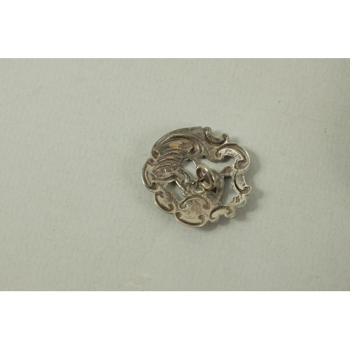 299 - A CASED SET OF 6 LATE VICTORIAN SILVER DRESS BUTTONS of embossed Rococo design with pierced seated f... 