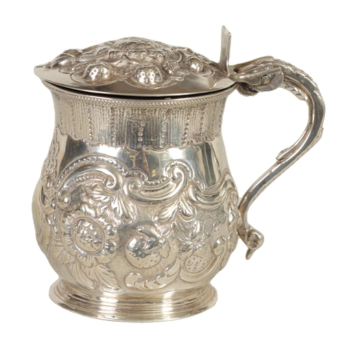 301 - A GEORGE IV SILVER MUSTARD POT AND LINER OF LARGE SIZE of lidded baluster form with embossed scroll ... 