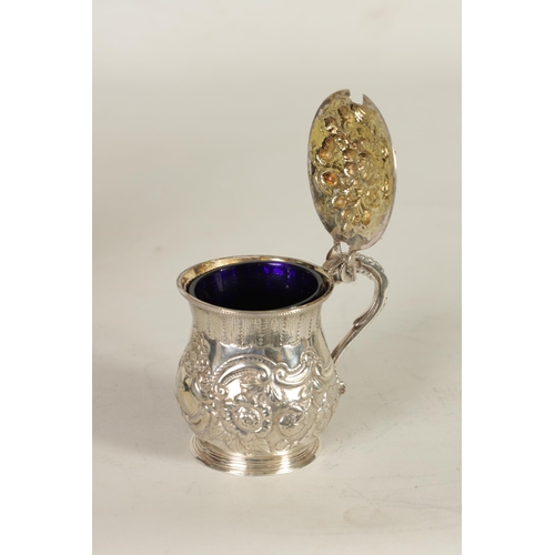 301 - A GEORGE IV SILVER MUSTARD POT AND LINER OF LARGE SIZE of lidded baluster form with embossed scroll ... 