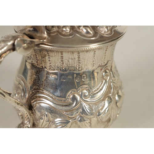 301 - A GEORGE IV SILVER MUSTARD POT AND LINER OF LARGE SIZE of lidded baluster form with embossed scroll ... 