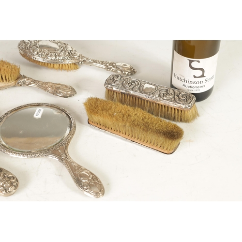 305 - A 19TH CENTURY SILVER DRESSING TABLE SET comprising of four brushes and two mirrors, having leaf and... 