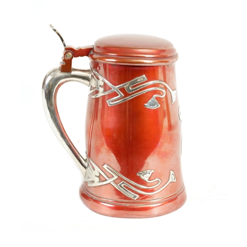 307 - AN AMERICAN ART NOUVEAU STERLING SILVER AND METAL LIDDED TANKARD of tapered form with red patinated ... 