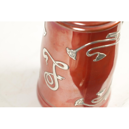 307 - AN AMERICAN ART NOUVEAU STERLING SILVER AND METAL LIDDED TANKARD of tapered form with red patinated ... 