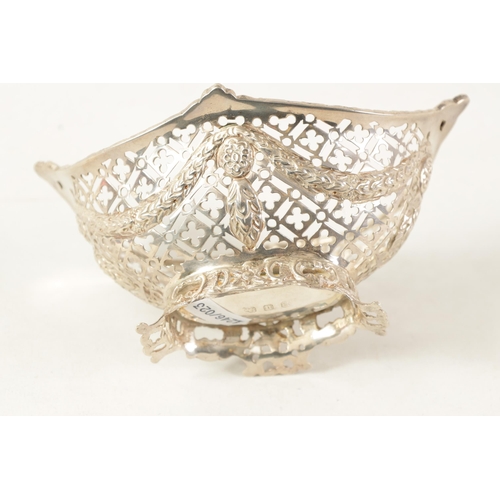 311 - A VICTORIAN HEAVY GAUGE OVAL SILVER BASKET of boat shape with raised leafwork side handles above a q... 