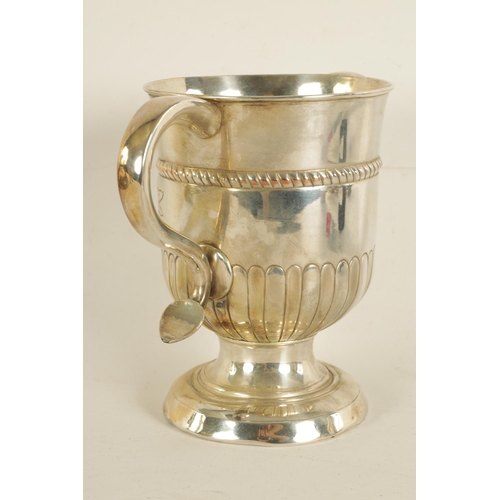 312 - A LATE GEORGIAN OLD SHEFFIELD PLATE TWO-HANDLED TROPHY CUP with half fluted body, engraved armorial ... 