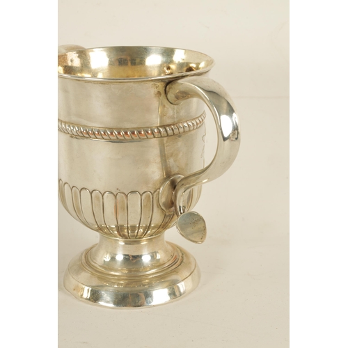 312 - A LATE GEORGIAN OLD SHEFFIELD PLATE TWO-HANDLED TROPHY CUP with half fluted body, engraved armorial ... 