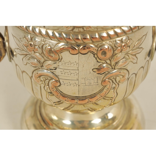 312 - A LATE GEORGIAN OLD SHEFFIELD PLATE TWO-HANDLED TROPHY CUP with half fluted body, engraved armorial ... 