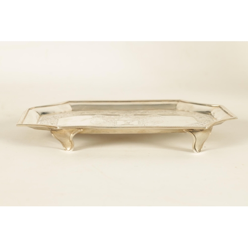 326 - A GEORGE III SILVER RECTANGULAR CARD TRAY with concave corners and engraved border enclosing a coat ... 