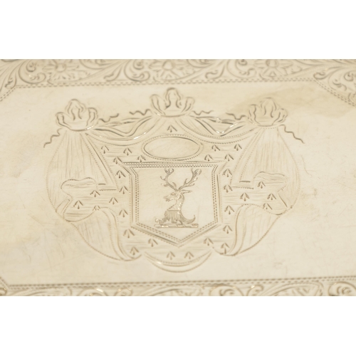 326 - A GEORGE III SILVER RECTANGULAR CARD TRAY with concave corners and engraved border enclosing a coat ... 