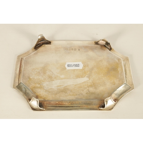 326 - A GEORGE III SILVER RECTANGULAR CARD TRAY with concave corners and engraved border enclosing a coat ... 