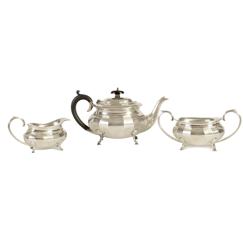 327 - A GEORGE V THREE-PIECE SILVER TEA SERVICE of oblate panelled form raised on splay feet; comprising t... 