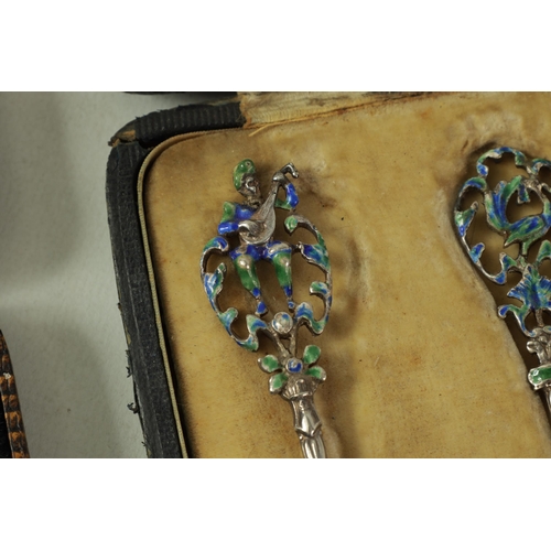 329 - A CASED SET OF 6 EDWARD VII SILVER AND ENAMEL TEASPOONS with cast openwork floral tops and leafwork ... 