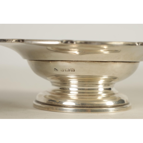 341 - A GEORGE VI SILVER SWEETMEAT DISH of plain pedestal form with dished centre enclosed by a scalloped ... 