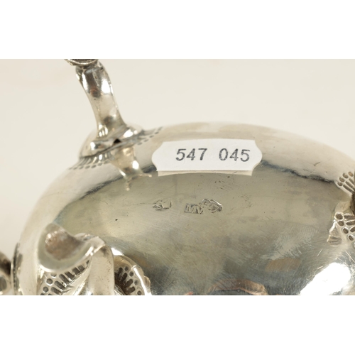 345 - A GEORGE III IRISH SILVER SAUCE BOAT with leaf-capped scroll handle, shell work knees and hoof feet ... 