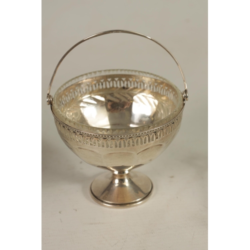 351 - A GEORGE V PEDESTAL SILVER SWEETMEAT BASKET of panelled form with pierced gadroon-edged rim and cut-... 