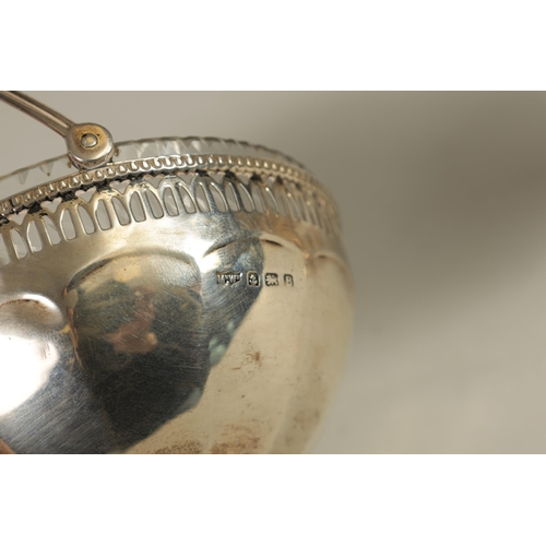 351 - A GEORGE V PEDESTAL SILVER SWEETMEAT BASKET of panelled form with pierced gadroon-edged rim and cut-... 