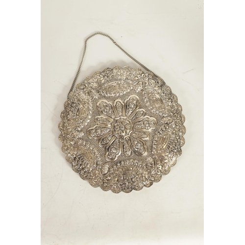 353 - A LATE 19TH CENTURY FINELY EMBOSSED SILVER CIRCULAR HANGING MIRROR - POSSIBLY TURKISH the ribbed-edg... 