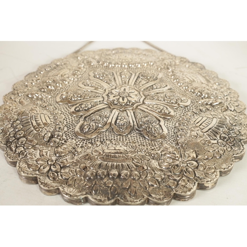 353 - A LATE 19TH CENTURY FINELY EMBOSSED SILVER CIRCULAR HANGING MIRROR - POSSIBLY TURKISH the ribbed-edg... 