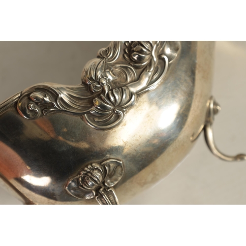 354 - A GEORGE V LARGE SILVER SAUCE BOAT with leaf capped double scroll handle, feather edged border and s... 