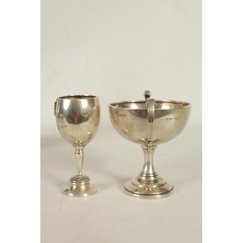 356 - A GEORGE V SILVER PRESENTATION TROPHY CUP & A SIMILAR SMALL SILVER CUP the larger of two handled ped... 