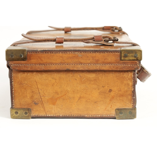 379 - A 19TH CENTURY LEATHER BOUND CARTRIDGE CASE with brass corners and leather straps revealing a lined ... 