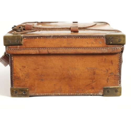 379 - A 19TH CENTURY LEATHER BOUND CARTRIDGE CASE with brass corners and leather straps revealing a lined ... 