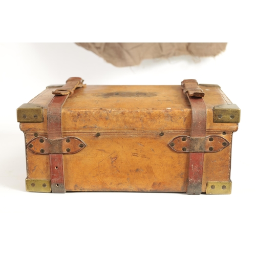 379 - A 19TH CENTURY LEATHER BOUND CARTRIDGE CASE with brass corners and leather straps revealing a lined ... 