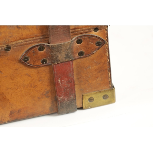 379 - A 19TH CENTURY LEATHER BOUND CARTRIDGE CASE with brass corners and leather straps revealing a lined ... 