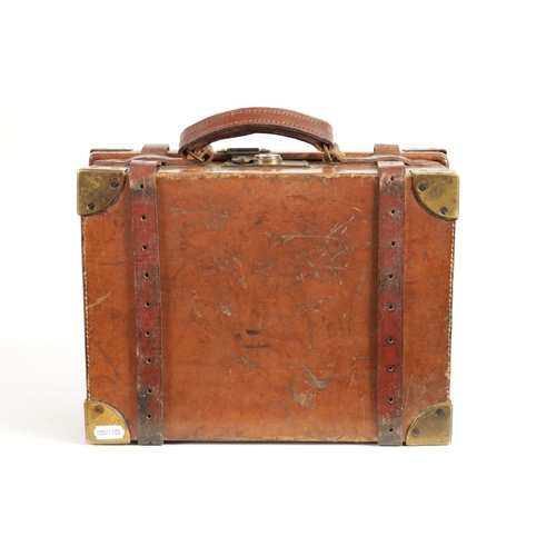 379 - A 19TH CENTURY LEATHER BOUND CARTRIDGE CASE with brass corners and leather straps revealing a lined ... 