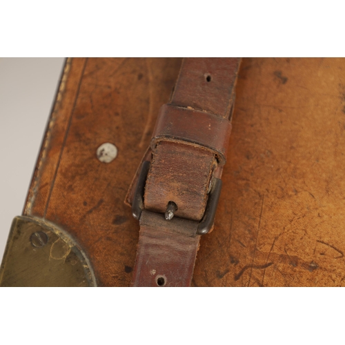 379 - A 19TH CENTURY LEATHER BOUND CARTRIDGE CASE with brass corners and leather straps revealing a lined ... 