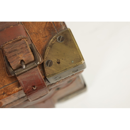 379 - A 19TH CENTURY LEATHER BOUND CARTRIDGE CASE with brass corners and leather straps revealing a lined ... 