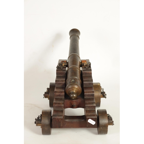 381 - AN 18TH/19TH CENTURY BRONZE STARTING CANNON with proof marks; mounted on an oak cutout carriage with... 